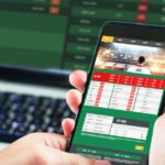 Businessman using smartphone against gambling app screen